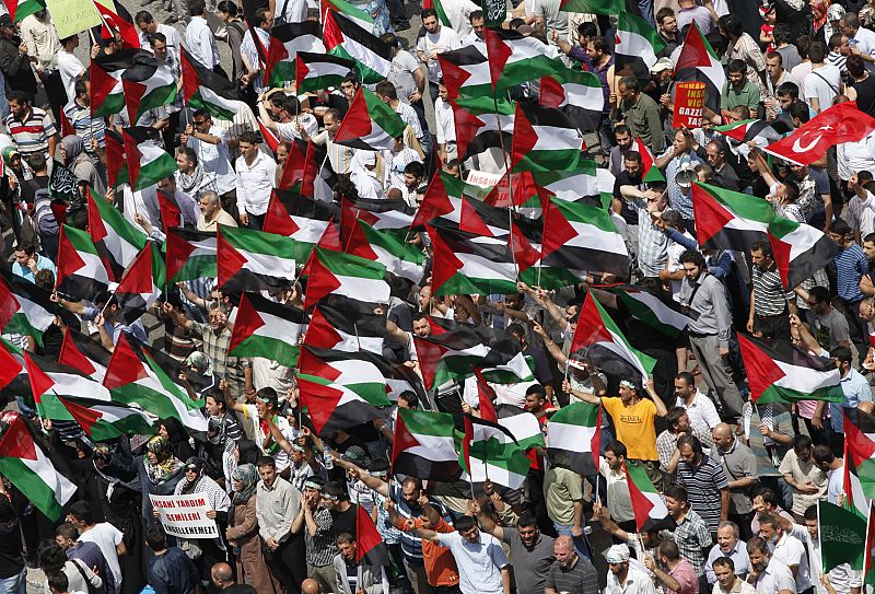 Demonstrators hold Palestinian flags during a protest against Israel at Taksim square in Istanbul