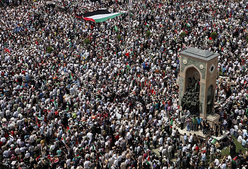 Demonstrators hold a large Palestinian flag during a protest against Israel at Taksim square in Istanbul