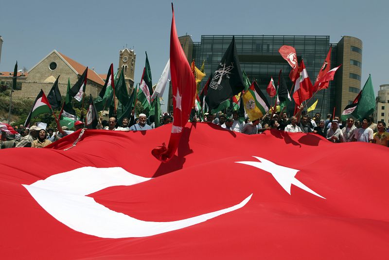 Lebanese leftists and Palestinians carry a giant Turkish flag during a protest against Israel's interception of aid ships sailing to the Gaza strip in front of the United Nations headquarters in Beirut