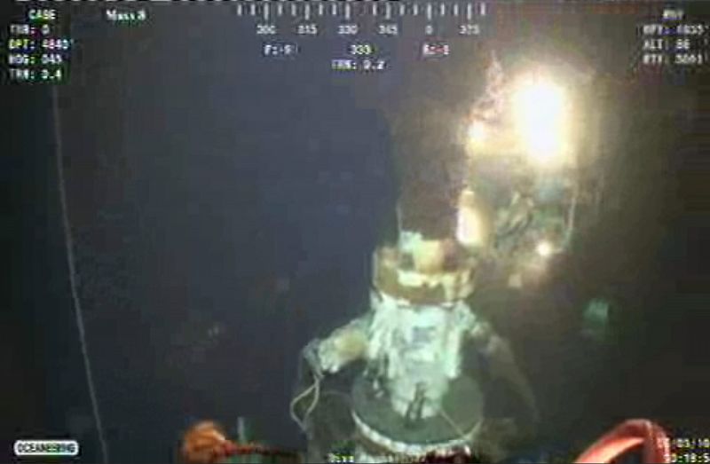 Remotely operated undersea vehicles work to cut and cap the riser pipe at the site of the Deepwater Horizon oil leak as it continues to spew oil into the Gulf of Mexico