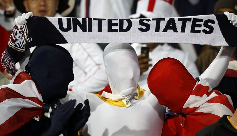 Fans of the US applaud and hold a scarf at the 2010 World Cup Group C soccer match against England in Rustenburg