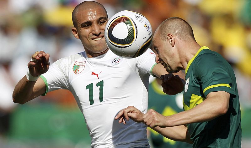 Algeria's Djebbour fights for the ball against Slovenia's Brecko during the 2010 World Cup Group C soccer match at Peter Mokaba stadium in Polokwane