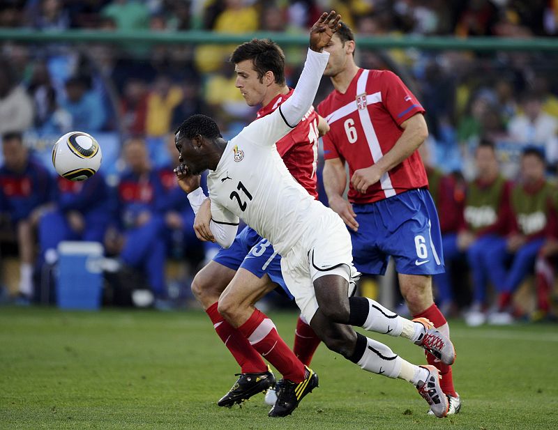 Ghana's Kwadwo Asamoah fights for the ball with Serbia's Aleksandar Lukovic during a 2010 World Cup Group D soccer match