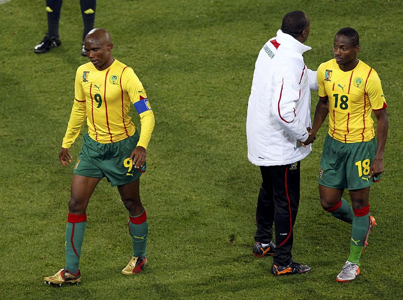 Cameroon's Eto'o and Eyong leave the field after their 2010 World Cup Group E soccer match against Japan at Free State stadium in Bloemfontein