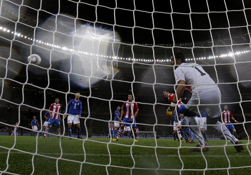 Paraguay's Alcaraz scores past Italy's goalkeeper Buffon during a 2010 World Cup Group F soccer match at Green Point stadium in Cape Town