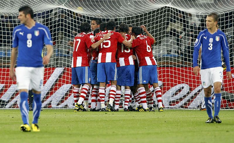 Paraguay's players celebrate Alcaraz's goal as Italy's Iaquinta and Criscito walk away during their 2010 World Cup Group F soccer match at Green Point stadium in Cape Town