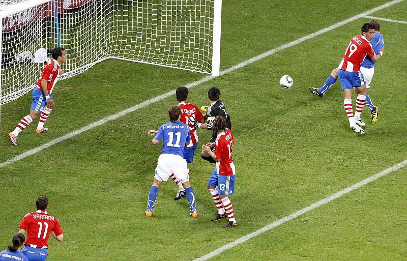 Italy's De Rossi scores past Paraguay's Barrios during a 2010 World Cup Group F soccer match at Green Point stadium in Cape Town