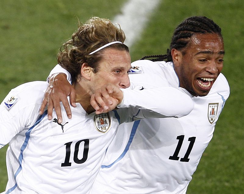 Uruguay's Forlan celebrates his goal with team mate Pereira during the 2010 World Cup Group A soccer match against South Africa in Pretoria