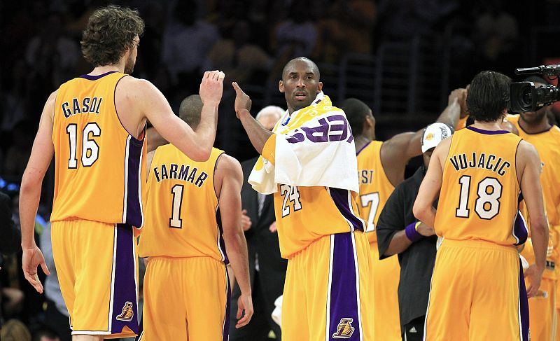 Lakers Bryant greets his teammates Gasol, Farmar and Vujacic as they made their way to the bench during Game 6 of the 2010 NBA Finals basketball series in Los Angeles,