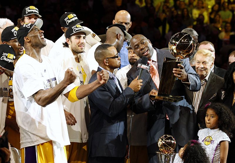 Kobe Bryant grita mientras Magic Johnson sostiene el título de campeón de la NBA.