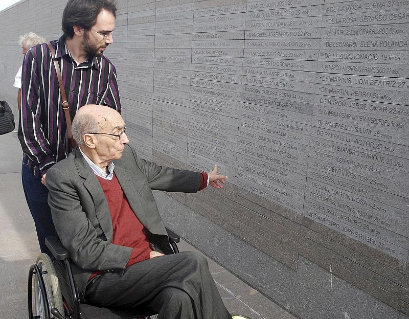 Writer Saramago looks at a wall with the names of people who disappeared during Argentina's military dictatorship in Buenos Aires