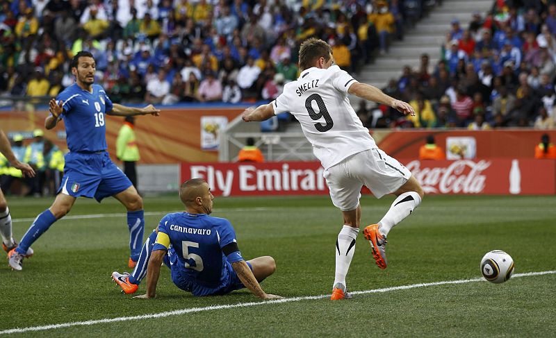 New Zealand's Shane Smeltz shoots to score the first goal as Italy's players look on during their 2010 World Cup Group F soccer match at Mbombela stadium in Nelspruit