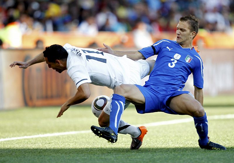 Italy's Criscito fights for the ball with New Zealand's Bertos during their 2010 World Cup Group F soccer match in Nelspruit