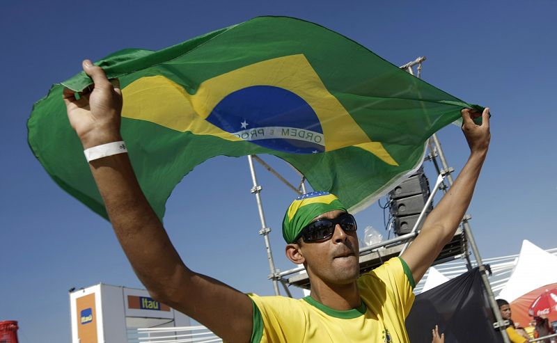 A supporter of the Brazilian national soccer team waves the national flag in Rio de Janeiro