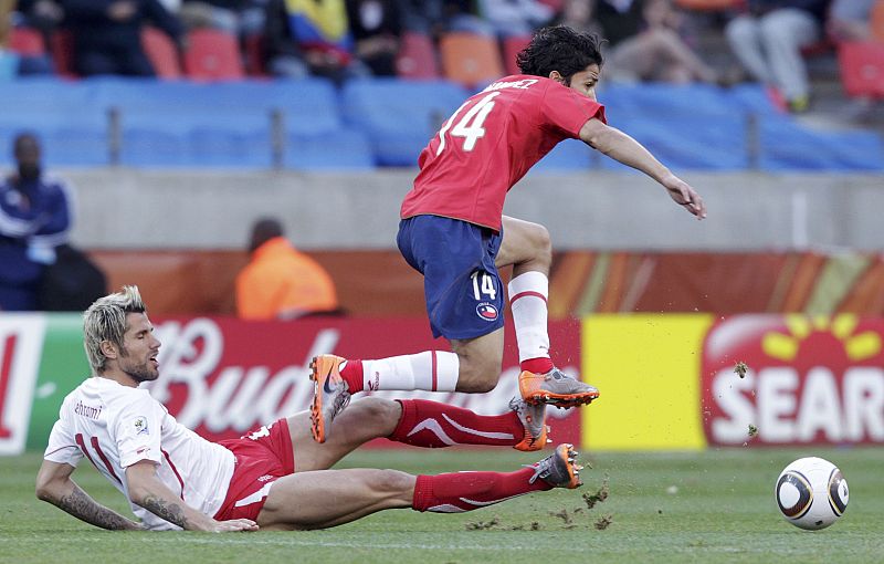 Switzerland's Valon Behrami fights for the ball against Chile's Matias Fernandez in Port Elizabeth