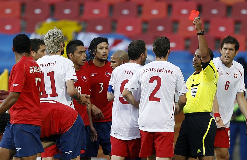 Referee Al Ghamdi of Saudi Arabia shows the red card to Switzerland's Behrami during a World Cup match against Chile in Port Elizabeth