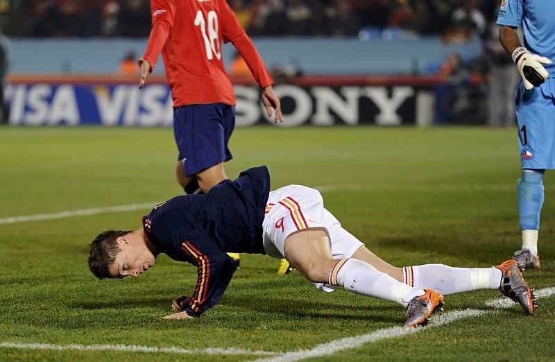 Spain's Fernando Torres recovers from a fall during a 2010 World Cup Group H match against Chile at Loftus Versfeld stadium in Pretoria