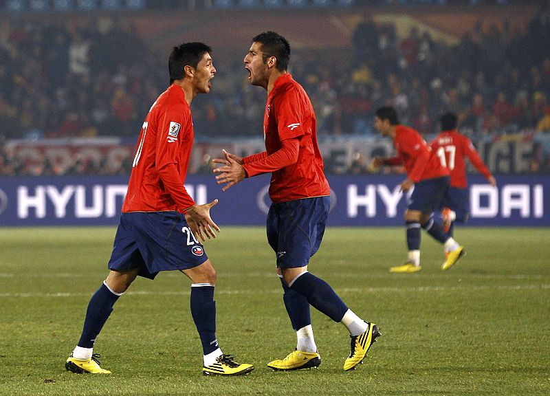 Chile's Millar celebrates with team mate Jara after scoring against Spain during a 2010 World Cup Group H match at Loftus Versfeld stadium in Pretoria