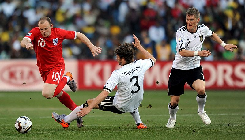 El delantero inglés Wayne Rooney (i) lucha por el balón con los alemanes Arne Friedrich (c) y Bastian Schweinsteiger (d) durante el partido de octavos