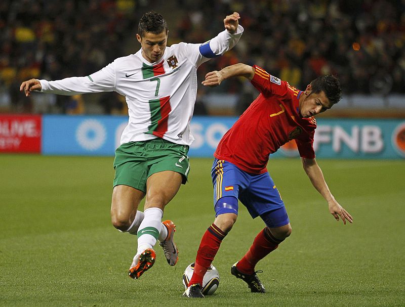 Portugal's Ronaldo fights for the ball against Spain's Villa during the 2010 World Cup second round soccer match at Green Point stadium in Cape Town