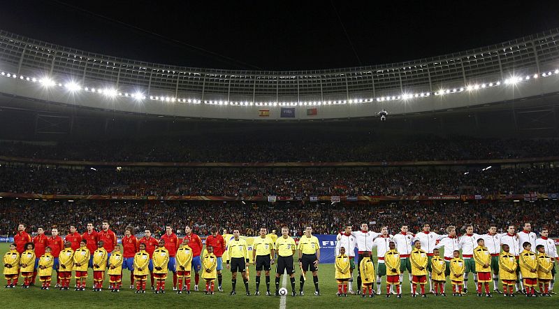 The Spain and Portugal soccer teams stand for the national anthem before their 2010 World Cup second round soccer match at Green Point stadium in Cape Town