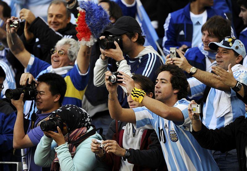 Soccer fans take pictures before the start of the 2010 World Cup quarter-final soccer match between Argentina and Germany at Green Point stadium in Cape Town