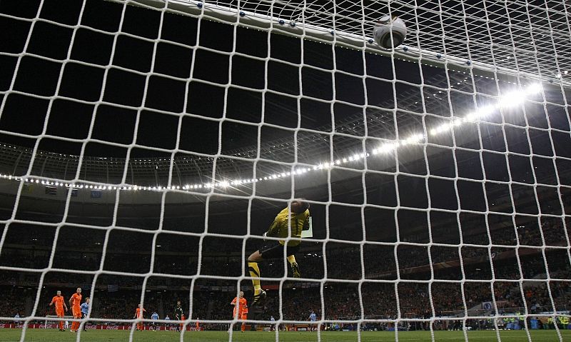 Uruguay's Forlan scores a goal past Netherlands' goalkeeper Stekelenburg during the 2010 World Cup semi-final soccer match in Cape Town