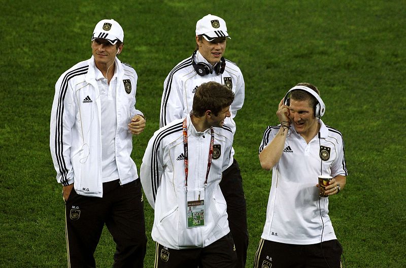 Germany's Mueller talks to team mate Schweinsteiger before World Cup semi-final soccer match against Spain at Moses Mabhida stadium in Durban