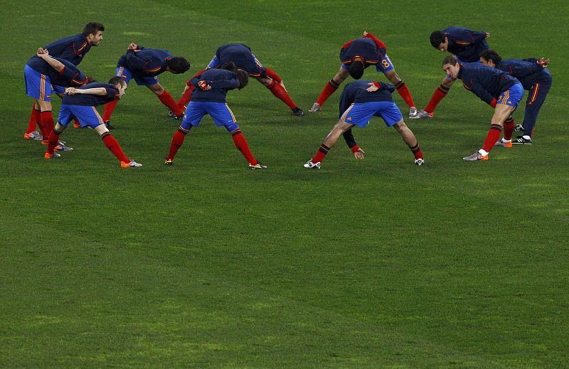 Spain's national soccer players warm up before their 2010 World Cup semi-final soccer match against Germany in Durban