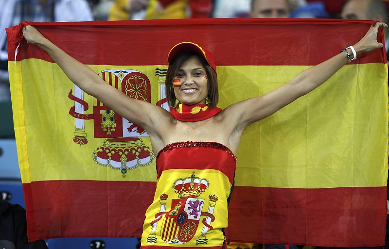 Spain fan holds up the national flag waits for the start of the 2010 World Cup semi-final soccer match between Germany and Spain in Durban