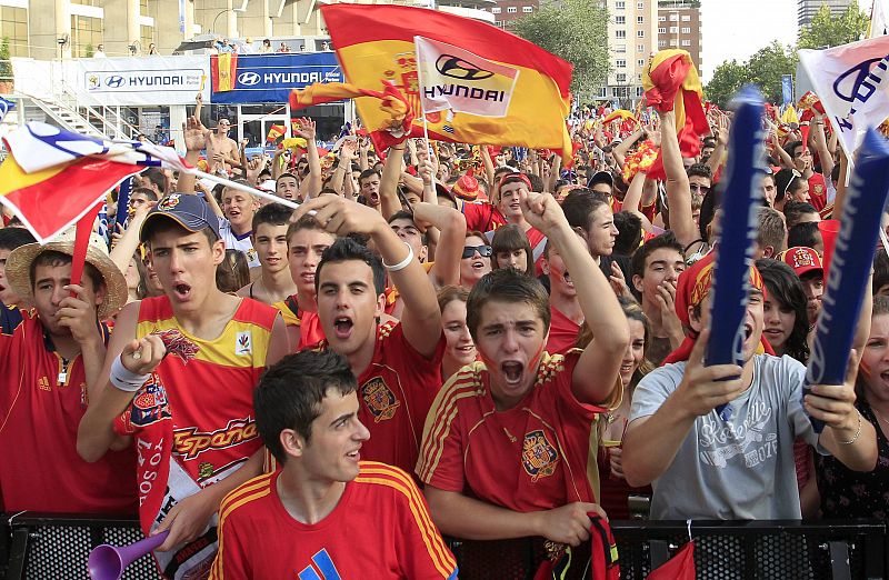 Spanish fans cheer before the start of the 2010 World Cup semi-final soccer match between Spain and Germany during an outdoor televised screening in Madrid