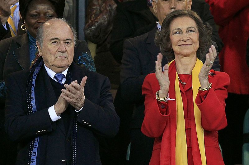 FIFA President Blatter claps next to Spain's Queen Sofia before the 2010 World Cup semi-final soccer match between Germany and Spain in Durban