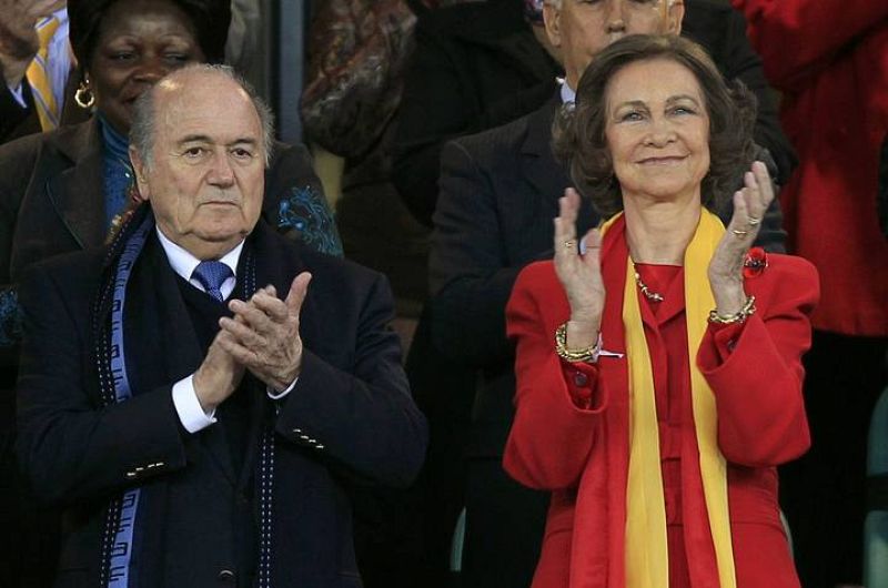 FIFA President Blatter claps next to Spain's Queen Sofia before the 2010 World Cup semi-final soccer match between Germany and Spain in Durban