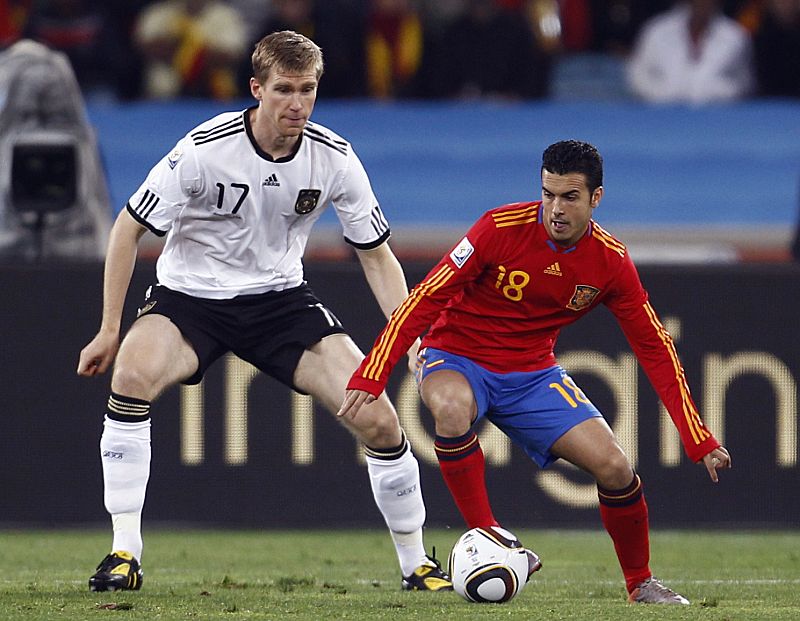 Germany's Per Mertesacker fights for the ball with Spain's Pedro during their 2010 World Cup semi-final soccer match at Moses Mabhida stadium