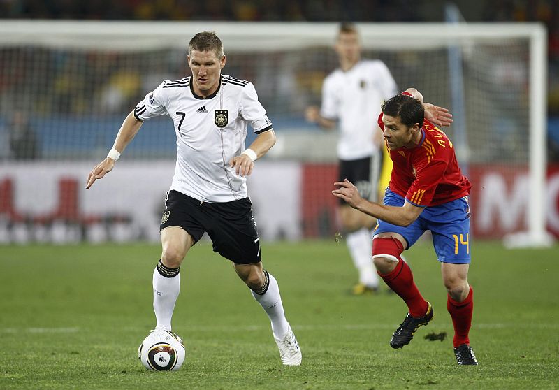 Germany's Schweinsteiger fights for the ball against Spain's Alonso during the 2010 World Cup semi-final soccer match at Moses Mabhida stadium in Durban