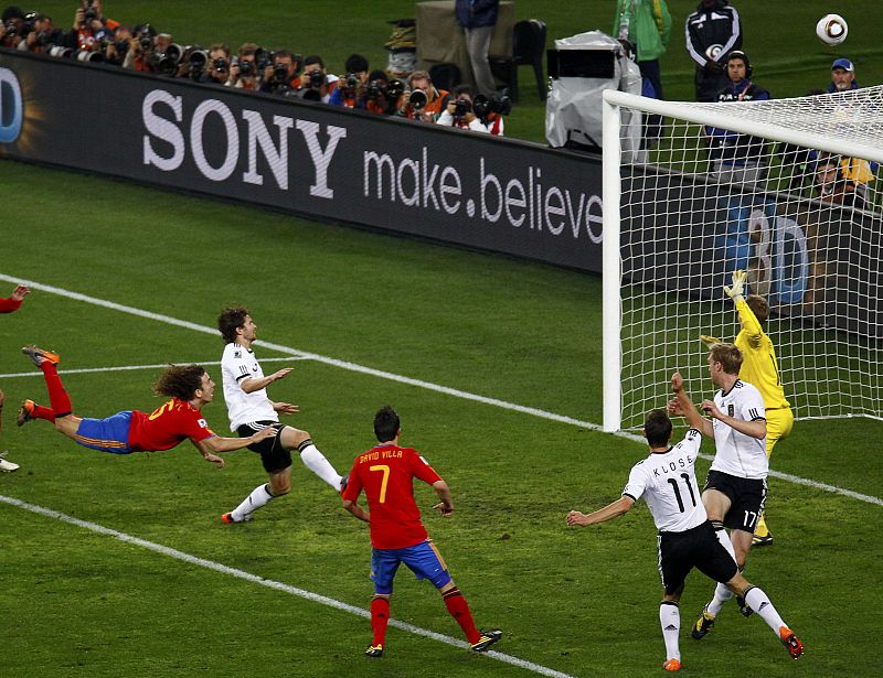 Spain's Puyol heads the ball over the goal during their 2010 World Cup semi-final soccer match against Germany at Moses Mabhida stadium in Durban