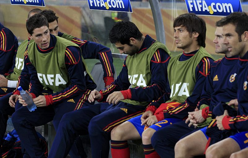 Spain's Torres sits on the bench with Albiol and Silva during the 2010 World Cup semi-final soccer match against Germany at Moses Mabhida stadium in Durban