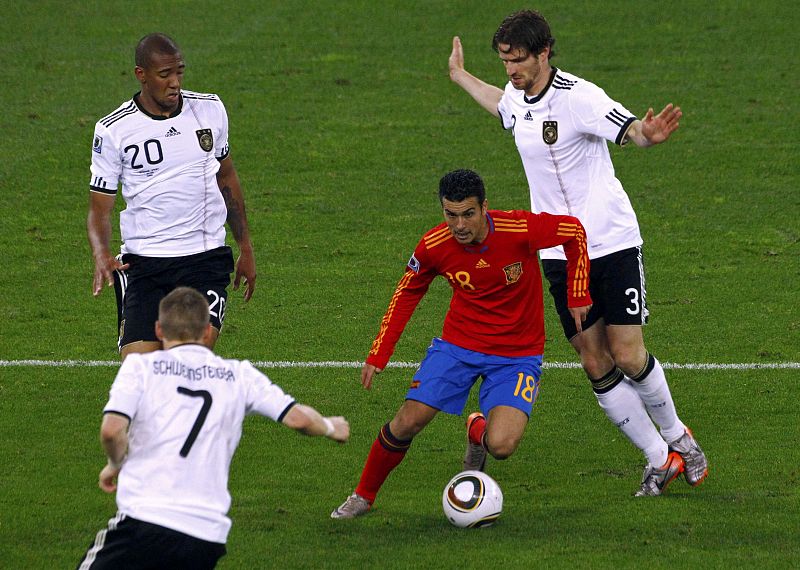 Spain's Pedro dribbles past Germany's Boateng and Friedrich during their 2010 World Cup semi-final soccer match at Moses Mabhida stadium in Durban