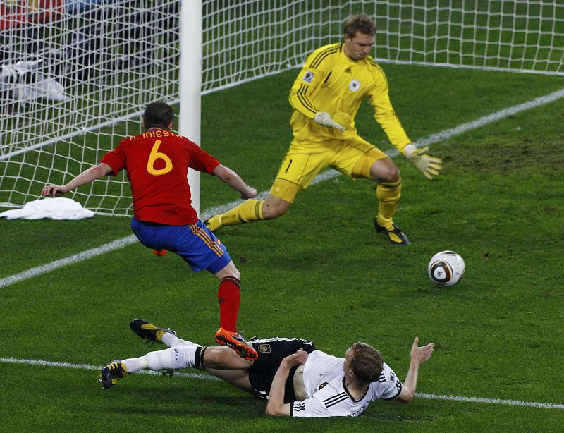 Germany's Mertesacker blocks Spain's Iniesta during their 2010 World Cup semi-final soccer match in Durban