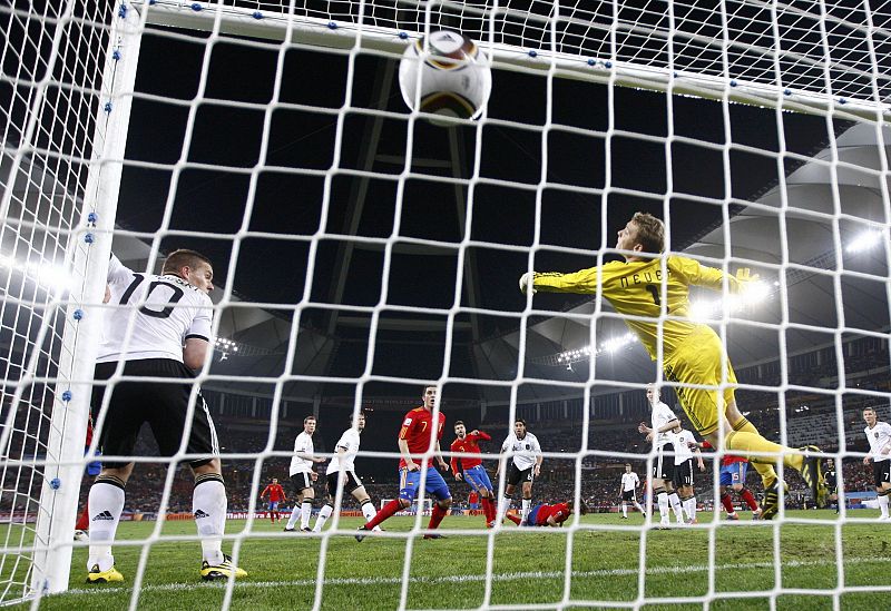 Spain's Puyol scores a goal past Germany's goalkeeper Neuer during the 2010 World Cup semi-final soccer match at Moses Mabhida stadium in Durban