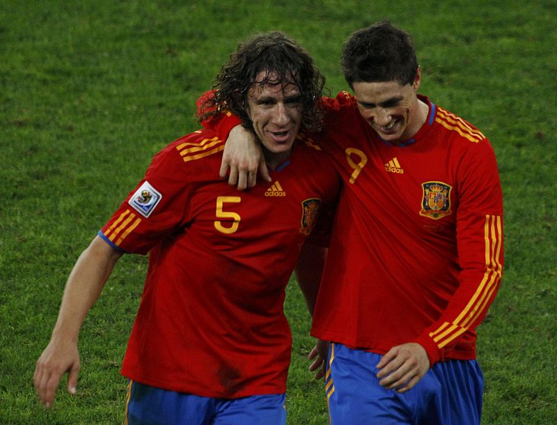 Spanish players Carles Puyol and Fernando Torres celebrate their victory against Germany after their 2010 World Cup semi-final soccer match at Moses Mabhida stadium in Durban