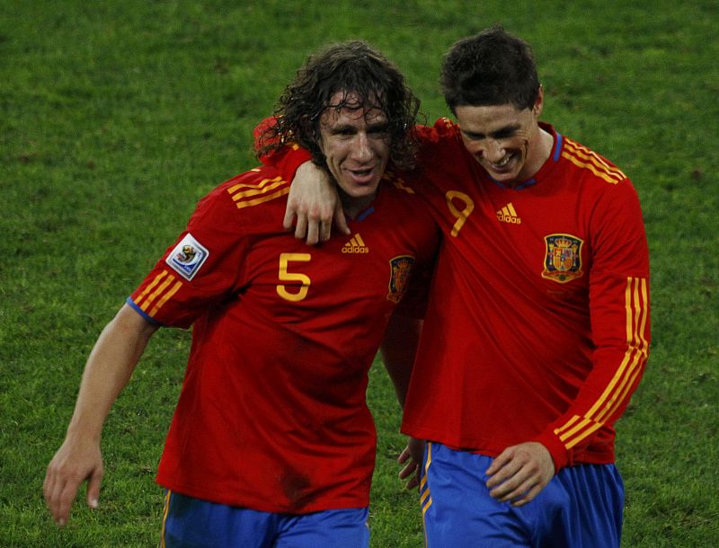 Spanish players Carles Puyol and Fernando Torres celebrate their victory against Germany after their 2010 World Cup semi-final soccer match at Moses Mabhida stadium in Durban
