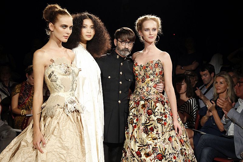 AFrench designer Franck Sorbier poses with models at the end of his Haute-Couture Fall/Winter 2010-2011 fashion show in Paris