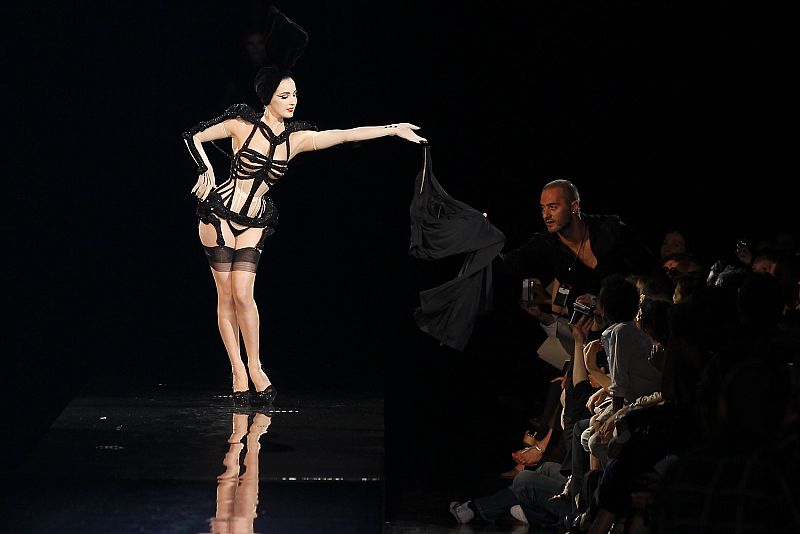 U.S. burlesque star Dita Von Teese presents a creation by French designer Jean-Paul Gaultier as part of his Haute-Couture Fall/Winter 2010-2011 fashion show in Paris