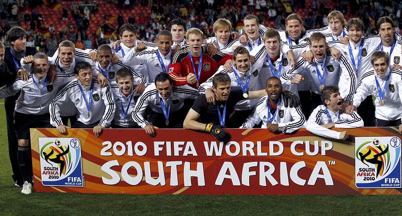 Germany's soccer team celebrate after the 2010 World Cup third place playoff soccer match against Uruguay in Port Elizabeth