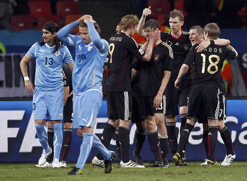 Uruguay's Diego Forlan and teammate Sebastian Abreu react after the final whistle in Port Elizabeth