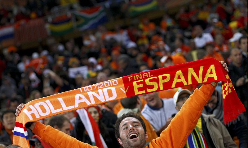 A fan holds up a scarf before the start of the 2010 World Cup final soccer match at Soccer City stadium