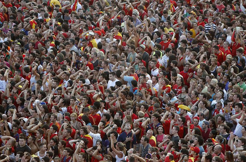 Spanish fans react as they watch the 2010 World Cup final soccer match between Spain and Netherlands on a public screen in Barcelona