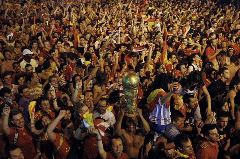 Spain's soccer fans celebrate after their team scored a goal during a public screening of the World Cup 2010 final soccer match in downtown Madrid