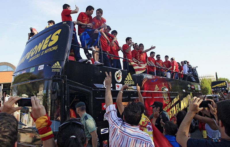 Spain's national soccer team players look out from an open-top bus as they leave Madrid's Moncloa Palace